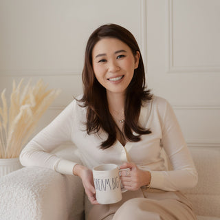 Starberry Jewelry Founder sitting on a couch holding a mug with text, smiling.