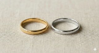 Gold and platinum rings on a beige fabric background